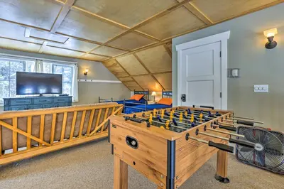 a room with a large game table in front of a room at Granby Home Stunning Mountain and Lake Views! in Granby