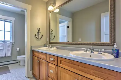 a bathroom with two sinks and a large mirror at Granby Home Stunning Mountain and Lake Views! in Granby