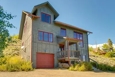 a house with red doors and a garage at Granby Home Stunning Mountain and Lake Views! in Granby