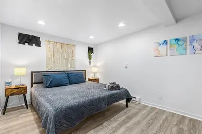 a bedroom with a bed with blue pillows at Basement with Full Kitchen and Near Downtown in Denver