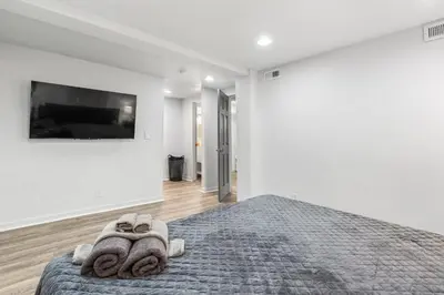 a bedroom with a bed with towels on it at Basement with Full Kitchen and Near Downtown in Denver