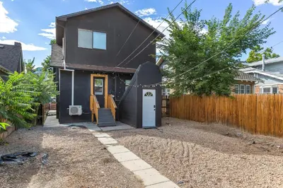 a house with a surfboard on the front of it at Basement with Full Kitchen and Near Downtown in Denver