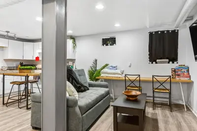 a living room and kitchen with a couch and a table at Basement with Full Kitchen and Near Downtown in Denver