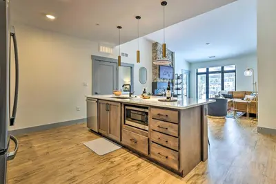a kitchen with a large island in the middle of a room at Condo with Mountain Views in Heart of Downtown! in Winter Park