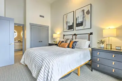 a bedroom with a bed with a blue dresser and a nightstand at Condo with Mountain Views in Heart of Downtown! in Winter Park