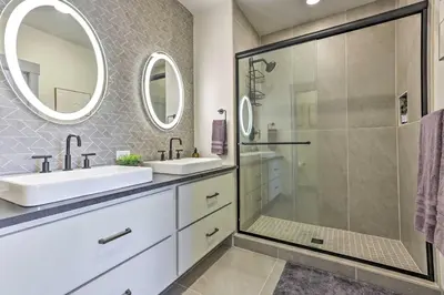 a bathroom with two sinks and a shower at Condo with Mountain Views in Heart of Downtown! in Winter Park