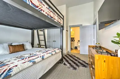 a bedroom with a bunk bed with a ladder at Condo with Mountain Views in Heart of Downtown! in Winter Park