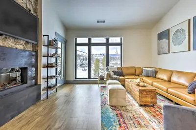 a living room with a couch and a fireplace at Condo with Mountain Views in Heart of Downtown! in Winter Park