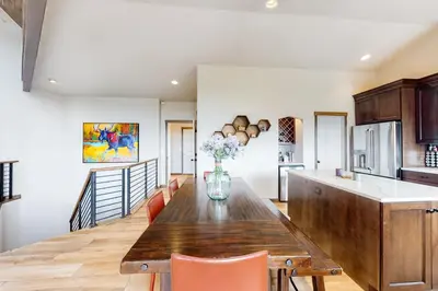 a kitchen with a wooden table with a vase of flowers on it at Tabernash Tranquility in Tabernash