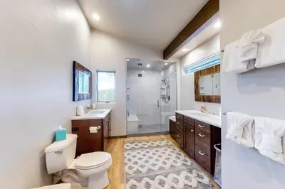 a bathroom with a toilet and a sink and a shower at Tabernash Tranquility in Tabernash