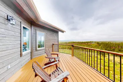 two chairs sitting on a deck on a house at Tabernash Tranquility in Tabernash