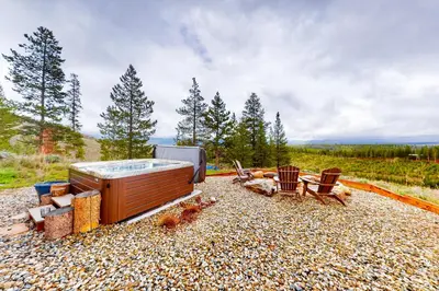 a hot tub and some chairs on a gravel ground at Tabernash Tranquility in Tabernash