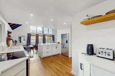 a kitchen with white cabinets and a counter top at The Golden Moose Chalet in Grand Lake