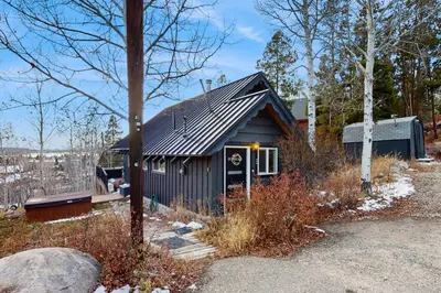 a small house with a black roof at The Golden Moose Chalet in Grand Lake