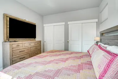 a bedroom with a bed and a flat screen tv at 6 Mi to Winter Park Resort Home with Free Shuttle in Winter Park