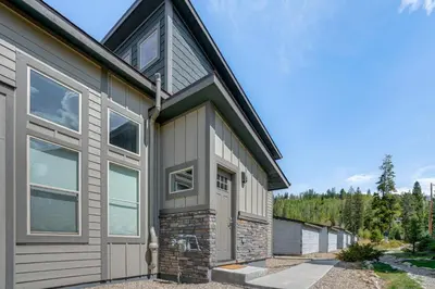 a home with a gambrel roof and a garage at 6 Mi to Winter Park Resort Home with Free Shuttle in Winter Park