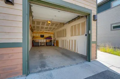 a garage with a white garage door and a driveway at 6 Mi to Winter Park Resort Home with Free Shuttle in Winter Park