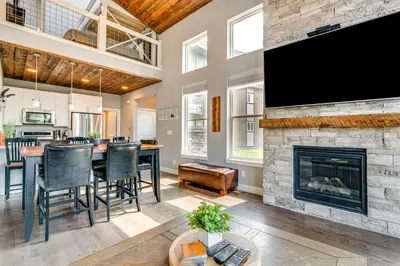 a living room with a fireplace and a flat screen tv at 6 Mi to Winter Park Resort Home with Free Shuttle in Winter Park