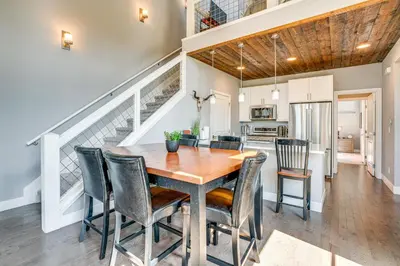 a kitchen and dining room with a wooden table and chairs at 6 Mi to Winter Park Resort Home with Free Shuttle in Winter Park