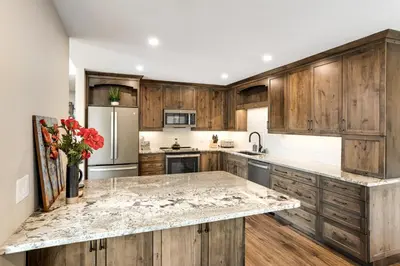 a kitchen with wooden cabinets and a marble counter top at Mount Royal in Frisco