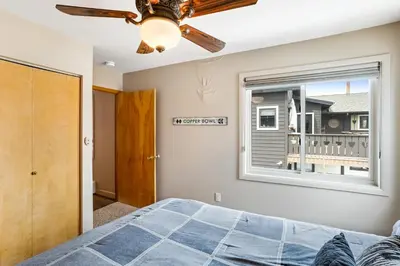a bedroom with a ceiling fan and a window at Mount Royal in Frisco