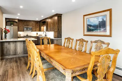 a dining room with a wooden table and chairs at Mount Royal in Frisco