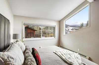 a bedroom with a bed and a large window at Mount Royal in Frisco