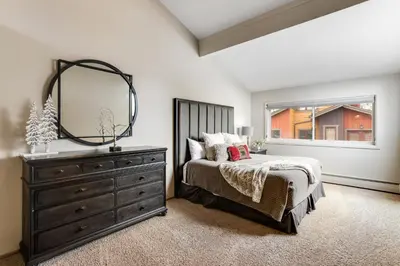 a bedroom with a bed and a dresser and a mirror at Mount Royal in Frisco