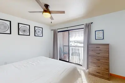 a bedroom with a bed and a ceiling fan at Grand Lake Lookout in Grand Lake