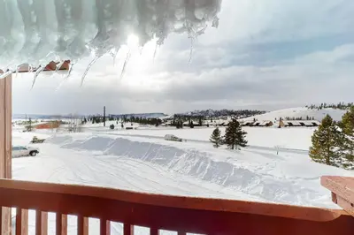 a view from the deck of a snow covered yard at Grand Lake Lookout in Grand Lake