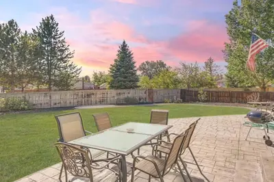 a patio with a table and chairs in a yard at Sleeps 12 - Thornton - 25 Min to Downtown Denver in Thornton