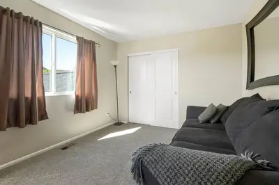 a living room with a couch and a window at Sleeps 12 - Thornton - 25 Min to Downtown Denver in Thornton