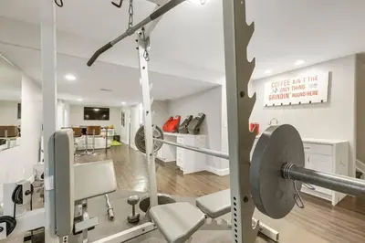 a room with a gym with a barbell at Sleeps 12 - Thornton - 25 Min to Downtown Denver in Thornton