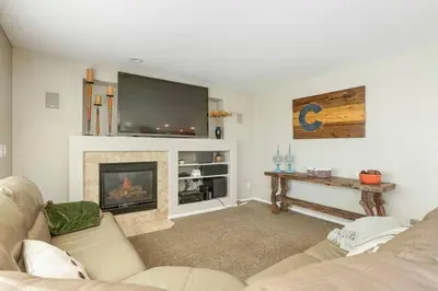a living room with a couch and a fireplace at Sleeps 12 - Thornton - 25 Min to Downtown Denver in Thornton