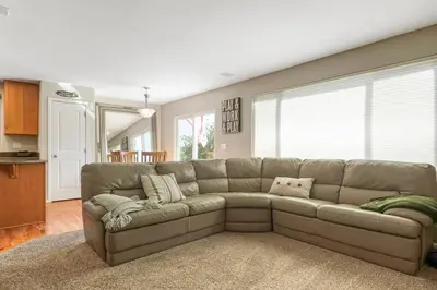 a living room with a brown couch in a room at Sleeps 12 - Thornton - 25 Min to Downtown Denver in Thornton