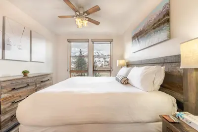 a bedroom with a large bed and a ceiling fan at Blue R Flats Bld 1 103 in Silverthorne