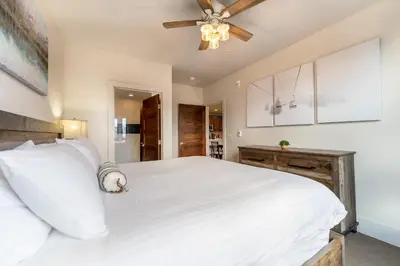 a bedroom with a white bed and a ceiling fan at Blue R Flats Bld 1 103 in Silverthorne
