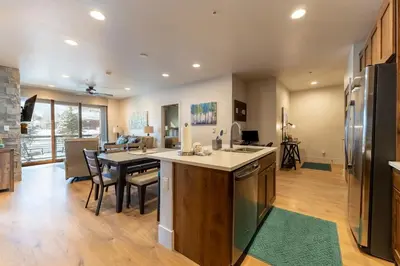 a kitchen and living room with a table and chairs at Blue R Flats Bld 1 103 in Silverthorne