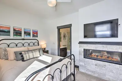 a bedroom with a bed and a fireplace at Modern Mountain Getaway, Walk to Grand Lake! in Grand Lake