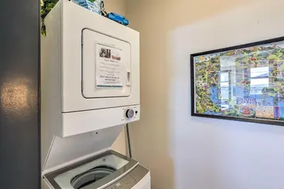 a white washer and dryer next to a wall at Modern Mountain Getaway, Walk to Grand Lake! in Grand Lake