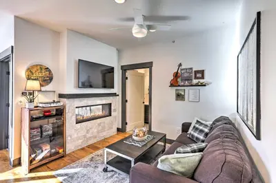 a living room with a couch and a fireplace at Modern Mountain Getaway, Walk to Grand Lake! in Grand Lake