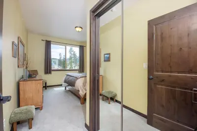 a bedroom with a bed and a sliding door at Trailhead Lodges Building 101 Unit 131 in Winter Park