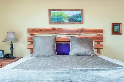 a bed with a wooden headboard in a bedroom at Trailhead Lodges Building 101 Unit 131 in Winter Park