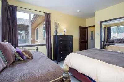 a bedroom with two beds and a window at Trailhead Lodges Building 101 Unit 131 in Winter Park