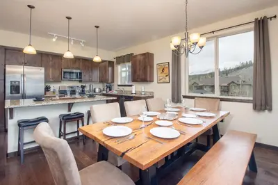 a kitchen and dining room with a wooden table and chairs at Trailhead Lodges Building 101 Unit 131 in Winter Park