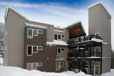 a large building with snow on the ground at Iron Horse Building J Unit 1309 in Winter Park
