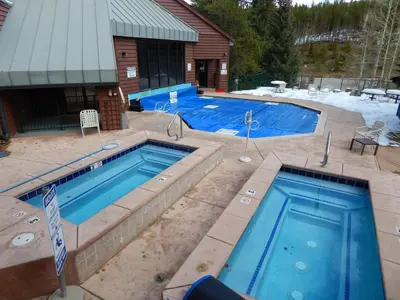 two swimming pools in front of a house at Iron Horse Building J Unit 1309 in Winter Park