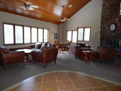 a living room with leather furniture and a stone fireplace at Iron Horse Building J Unit 1309 in Winter Park