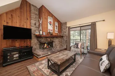 a living room with a fireplace and a tv at Beaver Village Unit #0333 in Winter Park