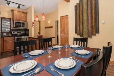 a dining room with a table with plates and silverware at Beaver Village Unit #0333 in Winter Park